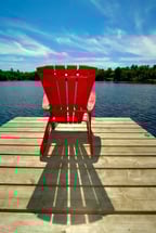 Red muskoka chair on dock