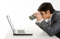 Man with binoculars and laptop