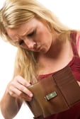 Woman looking into empty wallet