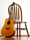 guitar resting against chair