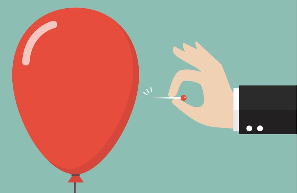 hand-pushing-needle-to-pop-the-balloon